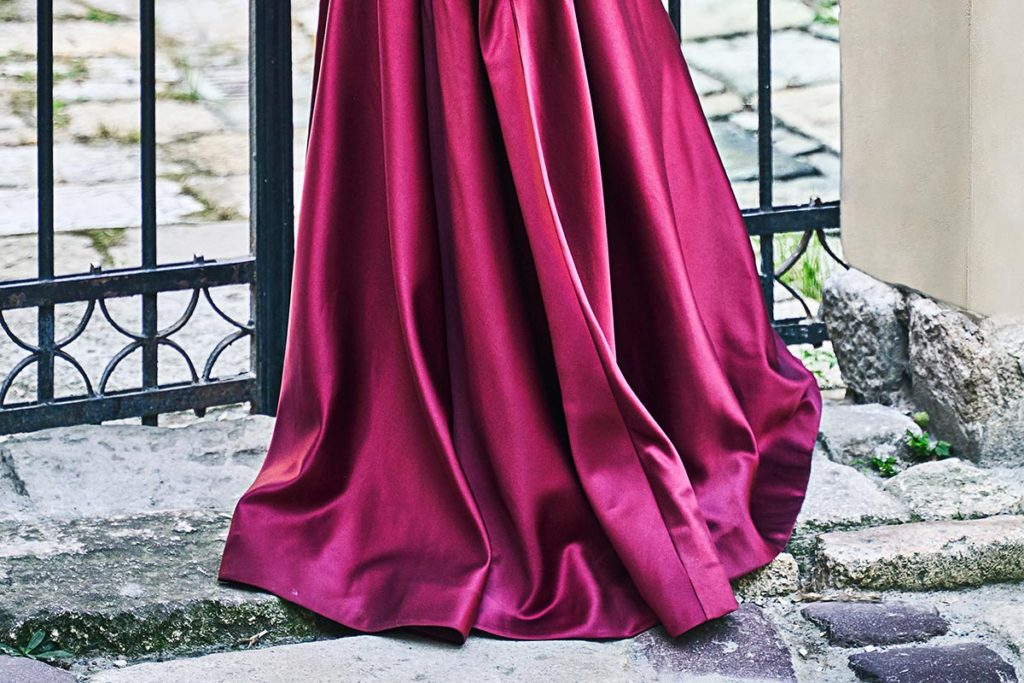 Closeup of the bottom of a bridesmaid's burgundy dress